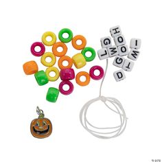 an assortment of bead charms and a keychain with the word halloween spelled out