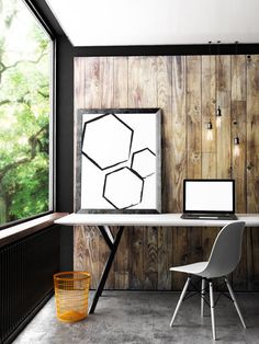 a white table sitting next to a window in a room with wood paneled walls