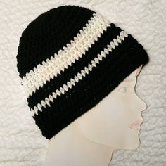 a black and white knitted hat on top of a mannequin head