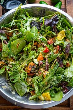 a salad in a bowl on top of a wooden table