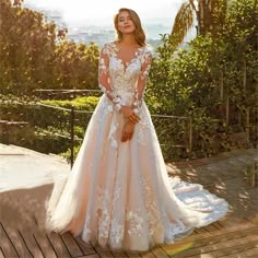 a woman in a wedding dress standing on a deck