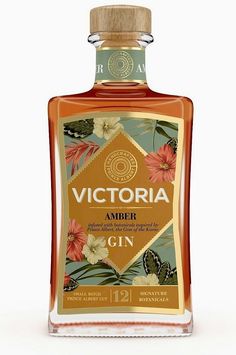 a bottle of victoria amber gin on a white background with flowers and butterflies around it