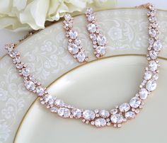 "This gorgeous Rose gold bridal jewelry set features dozens of oval and round CZ gemstones. This sparkling accessory is perfect for your wedding day! Size: Necklace: Length: 16'' and extends to 18\", Earrings: Length: 2'' You can choose a backdrop for this piece as well, please choose from the drop down menu. Matching bracelet: https://www.etsy.com/listing/265281912/rose-gold-bracelet-crystal-bridal Statement backdrop: https://www.etsy.com/listing/272743856/rose-gold-backdrop-necklace-bridal-bac Dazzling Rose Gold Jewelry Sets For Wedding, Gold Oval Jewelry Set For Wedding, Oval Gold Jewelry Set For Wedding, Rose Gold Bridal Jewelry Set, Rose Gold Necklace Set, Gold Bridal Jewelry, Rose Gold Bridal Jewelry, Bridal Backdrop Necklace, Rose Gold Wedding Jewelry