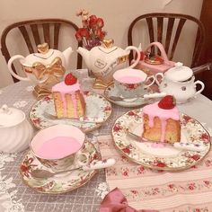 a table topped with plates and cups filled with cake