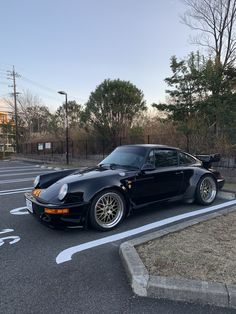 a black sports car parked in a parking lot