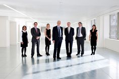 a group of business people standing in an empty room