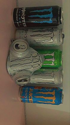 three cans of energy drink are stacked on top of each other