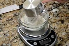 a blender sitting on top of a counter next to a knife and video player