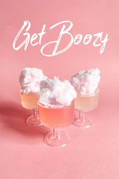 three glasses filled with ice cream on top of a pink background and the words get boozy written in white