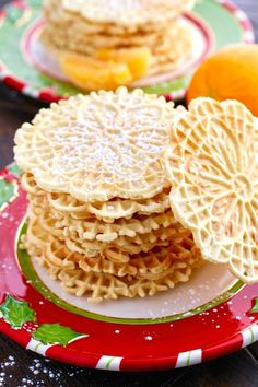 two plates with cookies and oranges on them