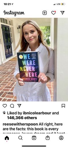 a woman holding up a book in front of a brick building with the caption we were never here