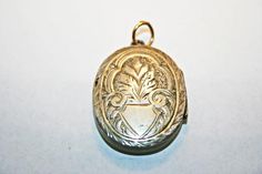 Antique Victorian silver locket, circa 1890s. In good condition, with minor wear and dings commensurate to age; along one edge of the cross, there is a hairline gap in the engraving, where the instrument used to emboss the locket's surface split through the metal. See photos for condition and measurements. Antique Etched Sterling Silver Locket Necklace, Antique Sterling Silver Etched Locket Necklace, Antique Etched Locket Necklace For Memorial, Antique Engraved White Gold Locket Necklace, Antique Silver Engraved Locket Necklace For Memorial, Antique White Gold Locket Necklace, Vintage White Gold Medallion Locket Necklace, Engraved Antique Silver Locket Necklace For Memorial, Victorian Etched Locket Necklace For Memorial