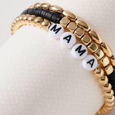 two bracelets with the word mama written on them in gold, black and white beads