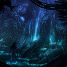 a man standing in the middle of a forest next to a waterfall with blue lights