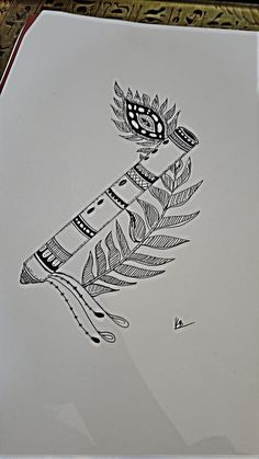 an ink drawing of a feather on a piece of paper