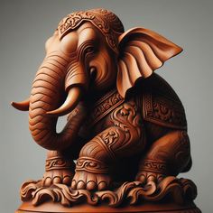 an intricately carved wooden elephant sitting on top of a table