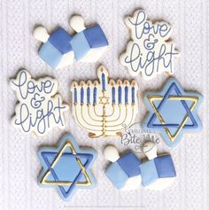 decorated cookies in the shape of menorah and hanukkah with love and light written on them