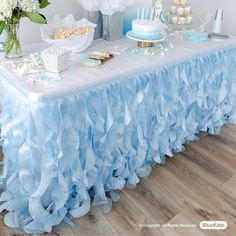 a table topped with lots of cake and cupcakes