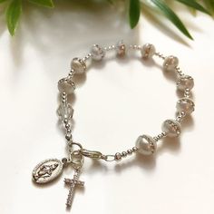 Bead: Freshwater Pearl & Clear Swarovski Crystal Size: CustomCharms: Cz Cross, Mother Mary If you have any other questions, please feel free to send me a message! Adjustable Silver Pearl Bracelet For Baptism, Elegant Silver Pearl Bracelet For Baptism, Elegant Silver Pearl Bracelet For First Communion, Elegant Hypoallergenic Rosary Bracelet For Baptism, Elegant Silver Rosary Bracelet For Baptism, Elegant Pearl Rosary Bracelet For Baptism, Pearl Jewelry For Baptism With Round Beads, Spiritual Pearl Jewelry For Baptism, Adjustable Hypoallergenic Rosary Bracelet For Wedding