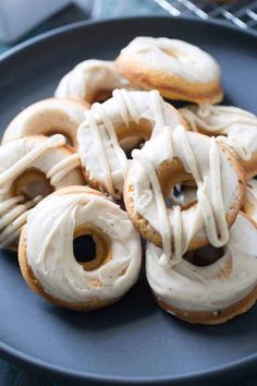 several glazed donuts on a plate with icing