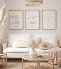 a living room filled with white furniture and pictures on the wall above it's coffee table