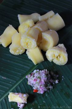 some food is laying out on a banana leaf and ready to be cut into pieces