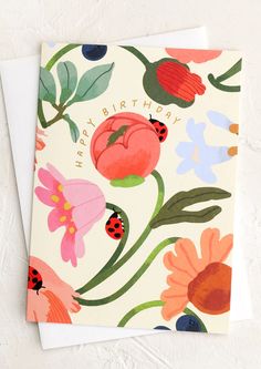 a birthday card with flowers and ladybugs on the front, says happy birthday