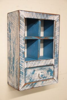 an old blue and white painted wooden cabinet