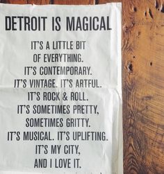 a piece of paper that says detroit is magic on the side of a wooden wall