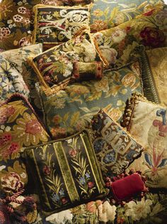 an assortment of pillows and rugs on display