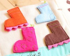 felt appliques made to look like boots and boots are sitting on a table