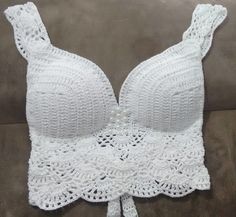 a white crochet bralet on a couch