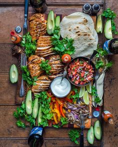 an assortment of food is laid out on a table