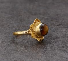 SIZE :- All Size Are Available. US1 TO US16, If Your Size Not Listed Feel Free to Contact us METAL :- Brass STONE;-Tiger eye Ring can be customized on request and gemstone can be made to any gemstone you want. Same Design Ring Are Upload With Any Gemstone. Please Visit Our Shop to View Complete Collection. If You Need Faster Shipping, Please Contact us Please Make Sure to Include The Correct Address During Before Order. You Can return Item within 30 Days After Successful Delivery. We Offer 100% Bohemian Gold Rings With Intricate Design, Handmade Brown Ring For Wedding, Handmade Vintage Gold Rings, Bohemian Yellow Gold Open Ring, Bohemian Gold Rings With Gemstones, Handmade Antique Gold Ring, Handmade Bohemian Yellow Gold Rings, Bohemian Gold Rings For Ceremonial Occasions, Bohemian Wedding Ring With Cabochon