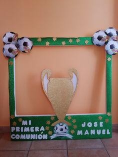 a soccer themed frame with balls and a trophy