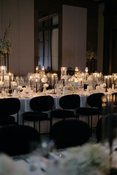 a long table is set up with candles and centerpieces for an elegant dinner