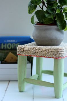 a potted plant sitting on top of a wooden stool