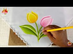 someone is drawing tulips on a piece of paper