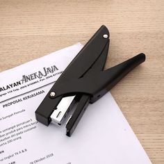 a pair of scissors sitting on top of a piece of paper next to a pen