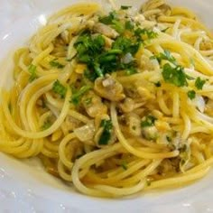 pasta with mushrooms and parsley in a white bowl