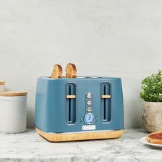 a blue toaster sitting on top of a counter