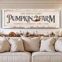 a couch with pillows and pumpkins on it in front of a sign that says the smith family pumpkin farm