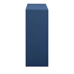 a tall blue vase sitting on top of a white wall