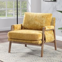 a yellow chair sitting on top of a rug