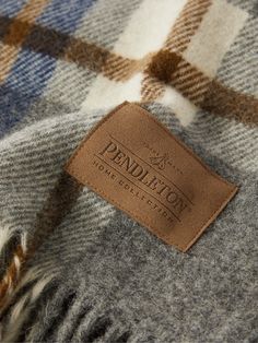 a close up of a label on a plaid blanket with the name pendleton written on it