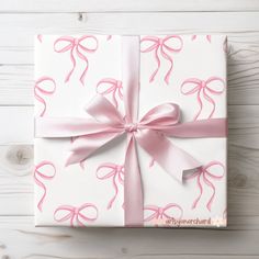 a wrapped present with pink ribbon and bow