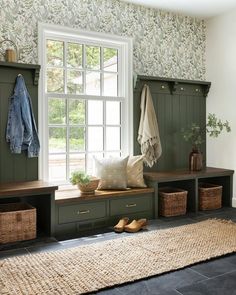 the inside of a room with green cabinets and baskets on the floor next to a window