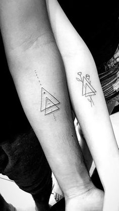 two people with matching tattoos on their arms