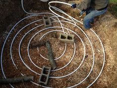 a man is working on some kind of garden hose that's connected to the ground