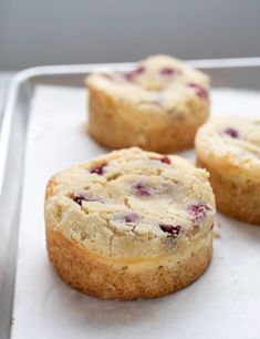 three muffins sitting on top of a baking pan